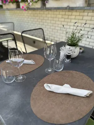 a table with wine glasses and napkins on it at Gasthof Ochsen in Nesslau