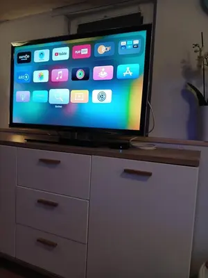 a flat screen tv sitting on top of a dresser at Ferienwohnung in Bühler nähe Appenzell in Bühler