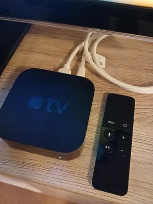 a remote control sitting on a table next to a cord at Ferienwohnung in Bühler nähe Appenzell in Bühler