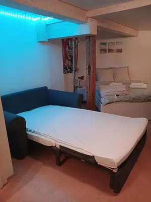 a bed and a couch in a room at Ferienwohnung in Bühler nähe Appenzell in Bühler