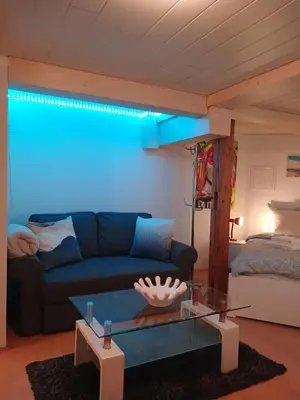 a living room with a couch and a blue light at Ferienwohnung in Bühler nähe Appenzell in Bühler