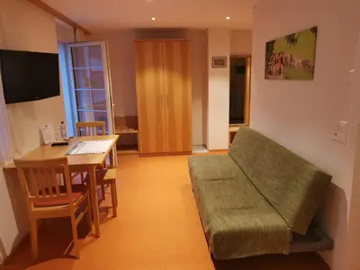 a living room with a couch and a table at Gästehaus Eisenhut in Walzenhausen