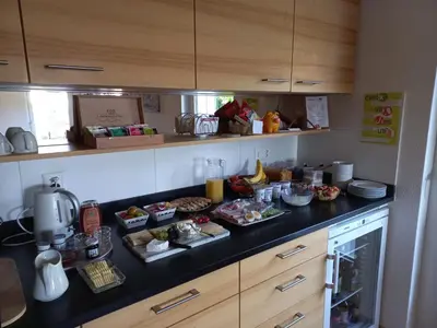 a kitchen counter with several plates of food on it at Gästehaus Eisenhut in Walzenhausen