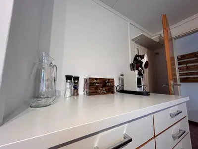 a kitchen with a white counter with a blender on it at Ferienwohnung mit Aussicht in Gais
