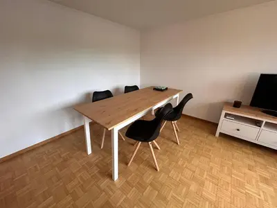 a table and chairs in a room with a television at Ferienwohnung mit Aussicht in Gais