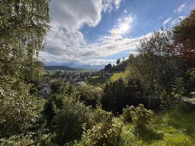 a view of a town from a hill with trees at Ferienwohnung mit Aussicht in Gais