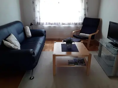 a living room with a couch and a coffee table at Zwinglis Ferienwohnung Rosi in Nesslau
