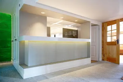a living room with a wall with a mirror at Anker Hotel Restaurant in Teufen