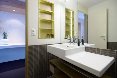 a bathroom with a white sink and a mirror at Anker Hotel Restaurant in Teufen