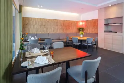 a dining room with a table and chairs at Newstar Hotel (Free Parking) in St. Gallen