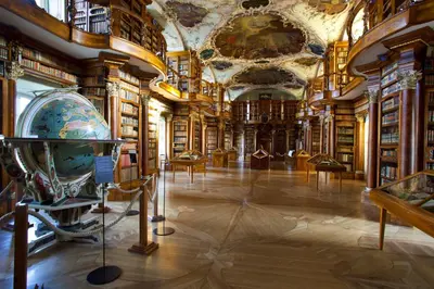 a library with bookshelves and a room filled with books at Newstar Hotel (Free Parking) in St. Gallen