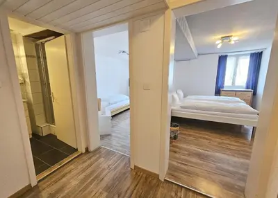 a bedroom with a bed and a walk in shower at Hotel Taverne zur Linde in Bischofszell