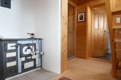 a hallway of a house with a room with a door at Nuessli in Wildhaus