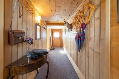 a hallway in a cabin with a wooden wall at Nuessli in Wildhaus