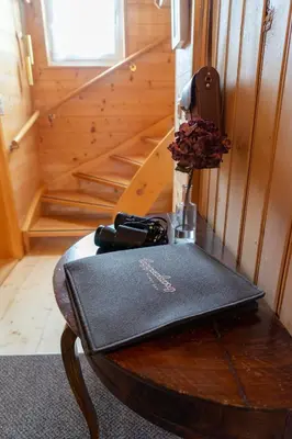 a wooden table with a vase on top of it at Nuessli in Wildhaus