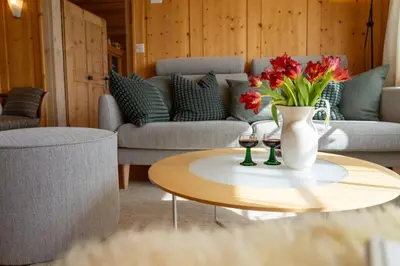a living room with a vase of flowers on a table at Nuessli in Wildhaus