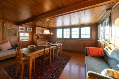 a living room with a table and chairs and a couch at Chammern in Nesslau