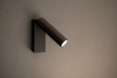 a light on a wall with a black handle at b_smart motel Amriswil in Amriswil