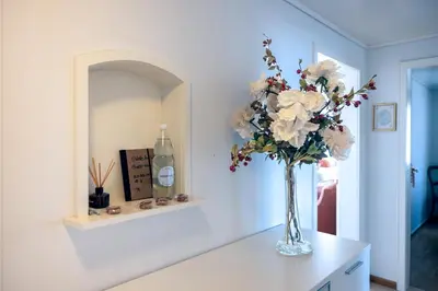 a vase of flowers on a counter in a room at Blattenheimat6 - im traditionellen Appenzeller Haus in Appenzell