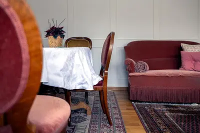 a living room with a table and a chair at Blattenheimat6 - im traditionellen Appenzeller Haus in Appenzell