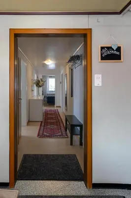 a hallway with a door leading to a living room at Blattenheimat6 - im traditionellen Appenzeller Haus in Appenzell