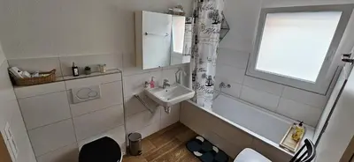 a bathroom with a sink and a toilet and a window at Private Etage 5 Min vom Bahnhof - Parken - Küche - Netflix in Widnau
