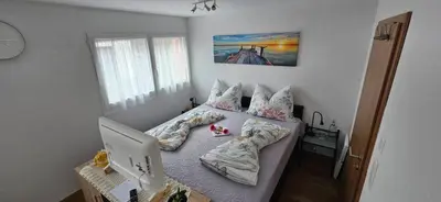 a bedroom with a bed with a laptop on it at Private Etage 5 Min vom Bahnhof - Parken - Küche - Netflix in Widnau