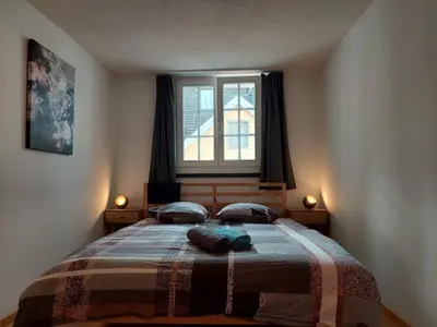 a bedroom with a bed with two pillows and a window at Global Citizen 5 in St. Gallen
