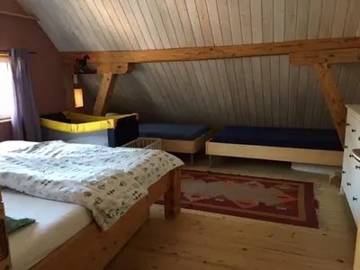 a bedroom with two beds in a attic at Farbige Wohnung Zentral in Herisau