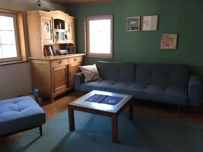 a living room with a couch and a coffee table at Farbige Wohnung Zentral in Herisau