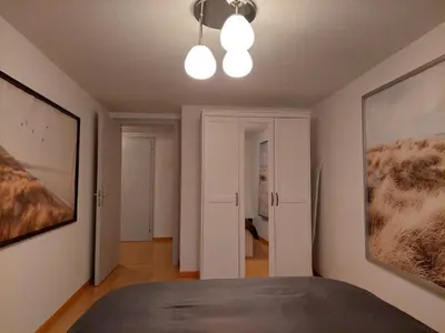 a bedroom with a bed and two paintings on the walls at Global Citizen 7 in St. Gallen