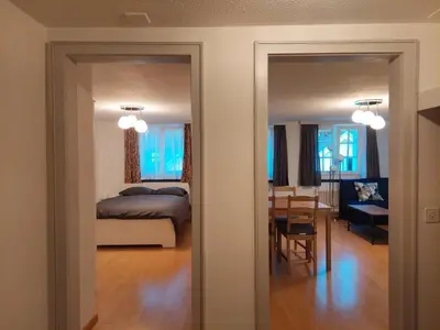 a bedroom and a dining room with a bed and a table at Global Citizen 7 in St. Gallen