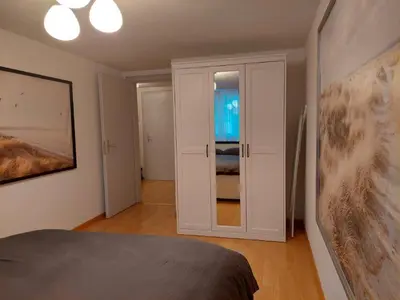 a bedroom with a bed and a door to a room at Global Citizen 7 in St. Gallen