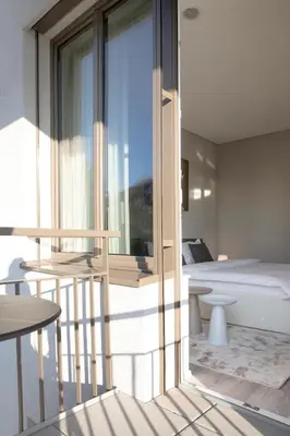a room with a balcony with a bed and a window at VISIONAPARTMENTS St Gallen - contactless check-in in St. Gallen