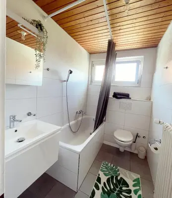 a kitchen with a table and a dining room at Sonniges Bodensee-Balkonidyll in Arbon