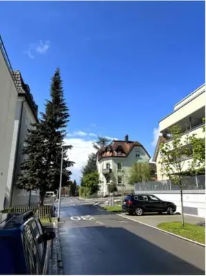 a street with a car parked on the side of the road at Gemütliches Studio nahe Bodensee in Arbon