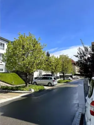 a street with cars parked on the side of the road at Gemütliches Studio nahe Bodensee in Arbon