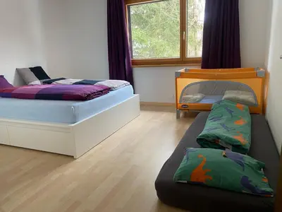a bedroom with two beds and a bunk bed at Rietidylle mit atemberaubendem Blick auf die Churfirsten in Wildhaus