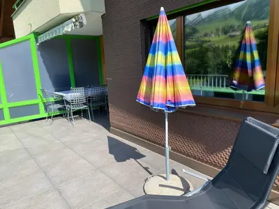 a colorful umbrella sitting on top of a patio at Rietidylle mit atemberaubendem Blick auf die Churfirsten in Wildhaus