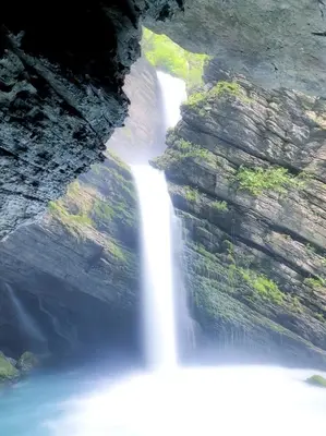 a waterfall is seen from the top of a cliff at Rietidylle mit atemberaubendem Blick auf die Churfirsten in Wildhaus