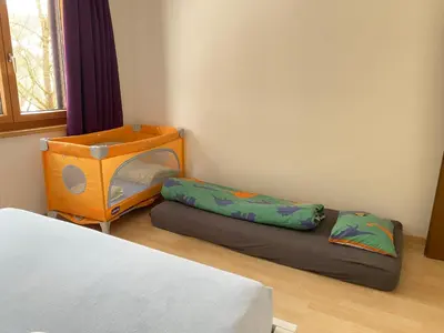 a room with two bunk beds and a bed sidx sidx sidx at Rietidylle mit atemberaubendem Blick auf die Churfirsten in Wildhaus
