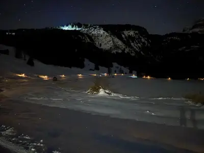 a snow covered field at night with a mountain at Rietidylle mit atemberaubendem Blick auf die Churfirsten in Wildhaus