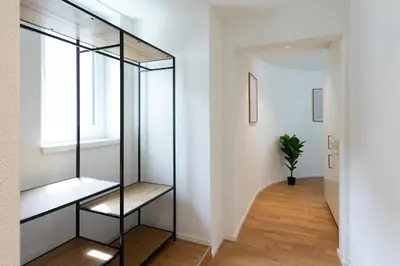 a glass shelf in a hallway with a window at INN JOY Apartments - Roter Platz in St. Gallen