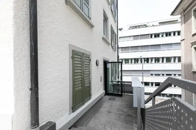 a balcony with a green door on a building at INN JOY Apartments - Roter Platz in St. Gallen