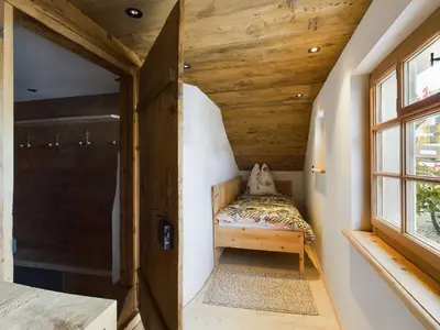 a small room with a small bed in the corner at Ferienwohnung Bärli Appenzell in Appenzell