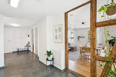 a living room with a mirror and a dining room at Klara 1022 - Olma, Spital, Uni St- Gallen in St. Gallen