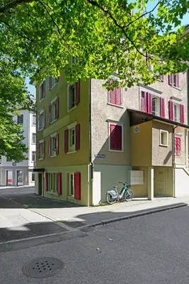 a bike parked next to a building on a street at book2stay modernes Apartment OLMA-Areal in St. Gallen