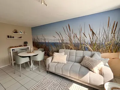 a living room with a couch and a table at Ferienwohnung SUN SAND SEA in Horn