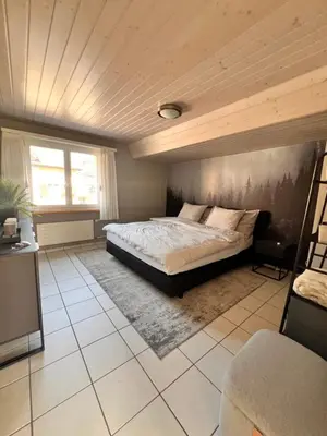 a bedroom with a bed and a wooden ceiling at Ferienwohnung SUN SAND SEA in Horn