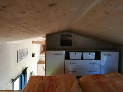 a room with a refrigerator and a bed in it at Tiny House im Grünen in Sankt Margrethen